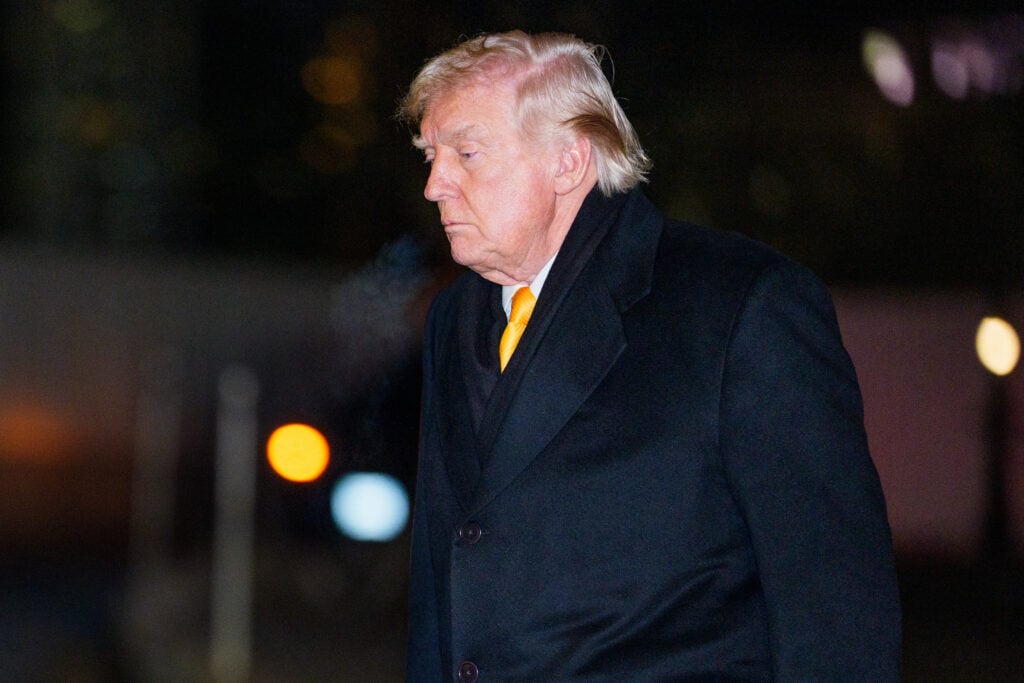 US President Donald Trump walks on the South Lawn of the White House after arriving on Marine One.