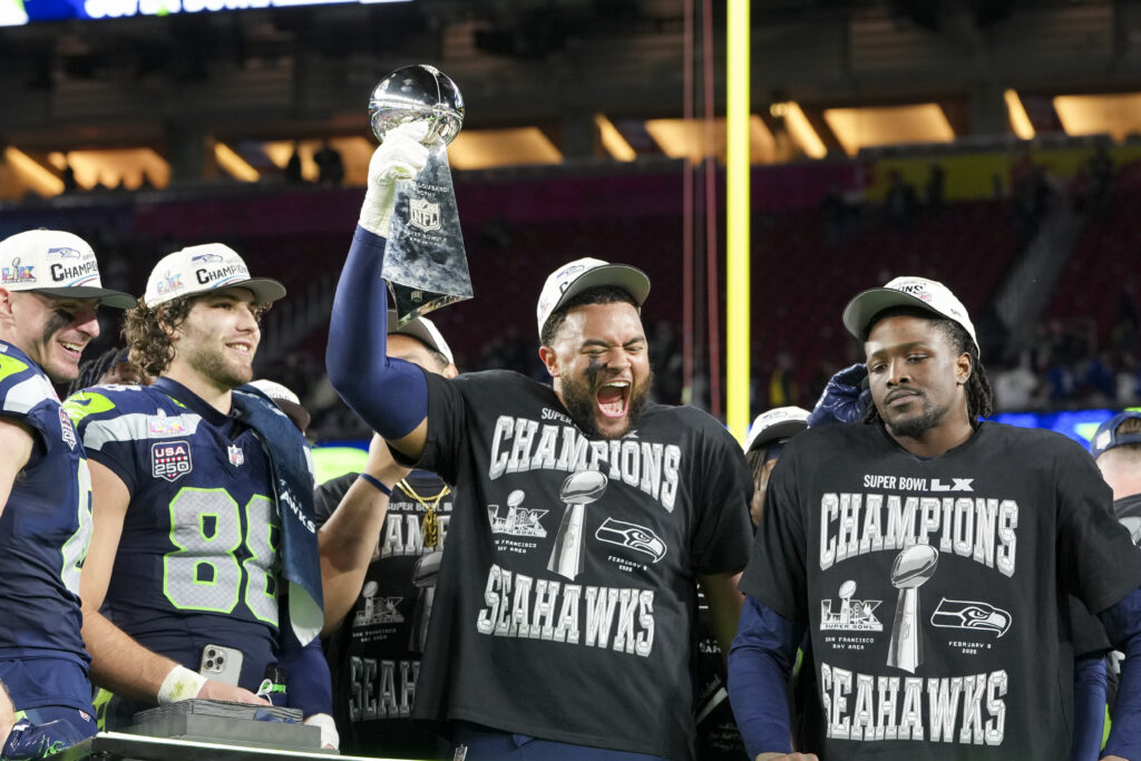 Mike Morris #94 and Tyrice Knight #48 of the Seattle Seahawks celebrate with the Vince Lombardi Trophy after the NFL Super Bowl LX football game against the New England Patriots at Levi Stadium on February 8, 2026 in Santa Clara, California.