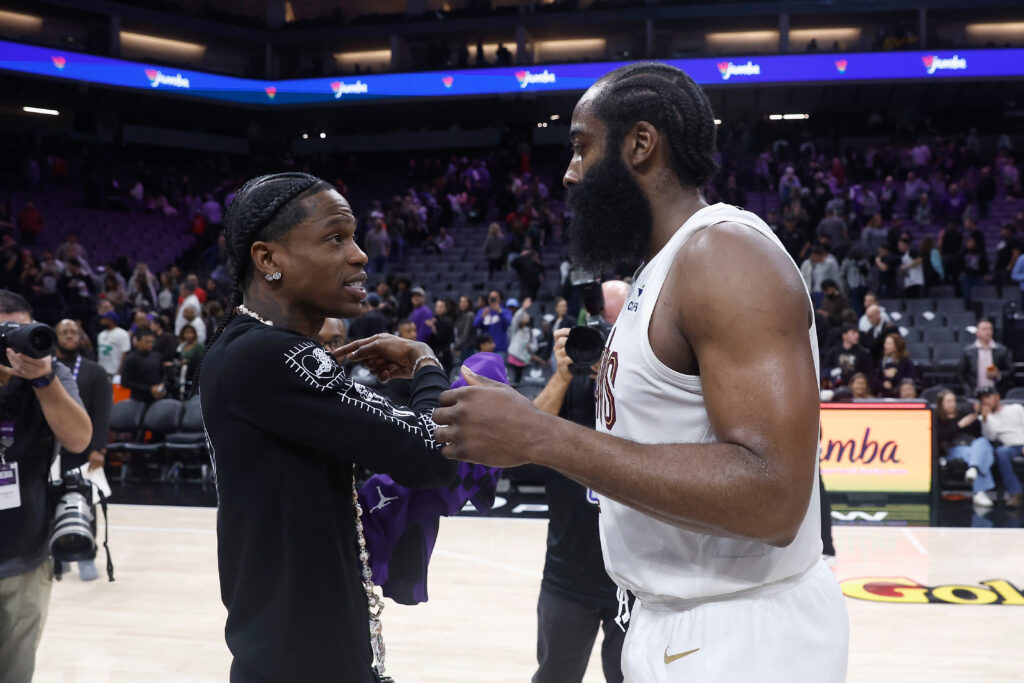 Recording artist Travis Scott talks with James Harden of the Cleveland Cavaliers after their win against the Sacramento Kings.