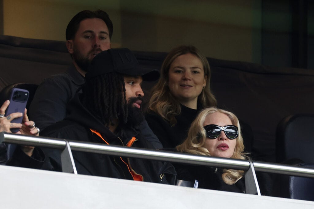 Madonna, American singer-songwriter and record producer, and Akeem Morris, watch on from the stands during the Barclays Women's Super League match between Tottenham Hotspur and Chelsea FC