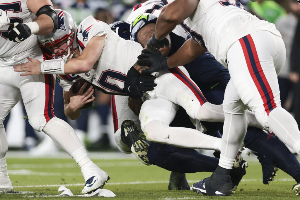 Drake Maye #10 of the New England Patriots is sacked against the Seattle Seahawks during the second half of Super Bowl LX at Levi's Stadium on February 08, 2026 in Santa Clara, California.