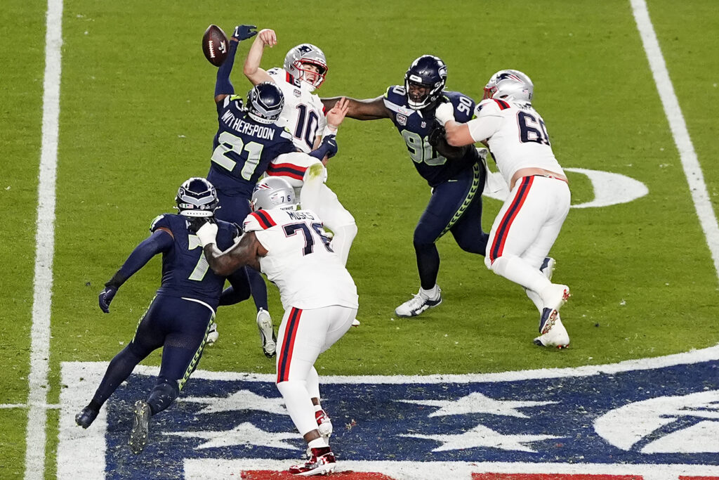 Devon Witherspoon #21 of the Seattle Seahawks forces a fumble against Drake Maye #10 of the New England Patriots during the fourth quarter in Super Bowl LX at Levi's Stadium on February 08, 2026 in Santa Clara, California.