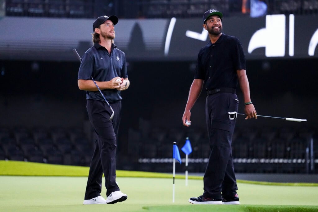 Tommy Fleetwood and Tony Finau of Los Angeles Golf Club warm up before a match against The Bay Golf Club at SoFi Center on February 09, 2026 in Palm Beach Gardens, Florida