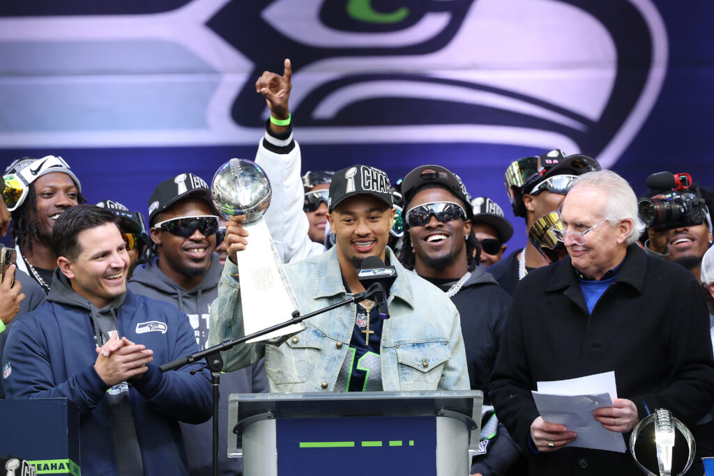 Jaxon Smith-Njigba #11 of the Seattle Seahawks raises the Lombardi Trophy during the Seattle Seahawks Super Bowl LX victory celebration and parade at Lumen Field on February 11, 2026 in Seattle, Washington.