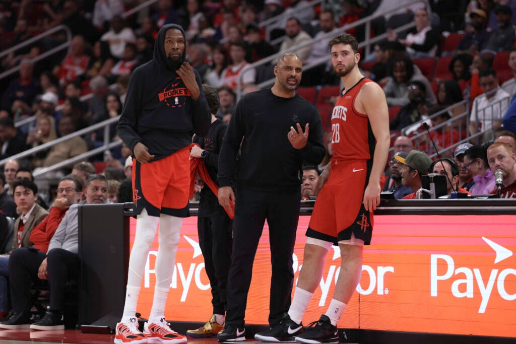 Kevin Durant #7, head coach Ime Udoka and Alperen Sengun #28 of the Houston Rockets look on during the third quarter against the Los Angeles Clippers at Toyota Center on February 11, 2026.