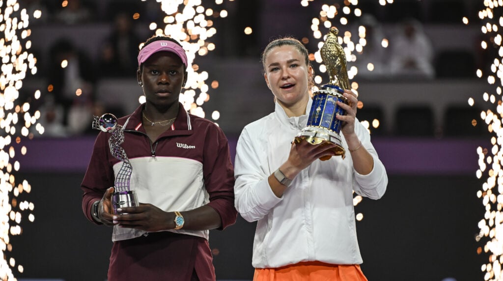 Karolina Muchova of the Czech Republic with the Golden Falcon Trophy stands with runner-up Victoria Mboko of Canada, during the trophy ceremony for the 2026 Qatar TotalEnergies Open at the Khalifa International Tennis and Squash Complex in Doha, Qatar, February 14, 2026.