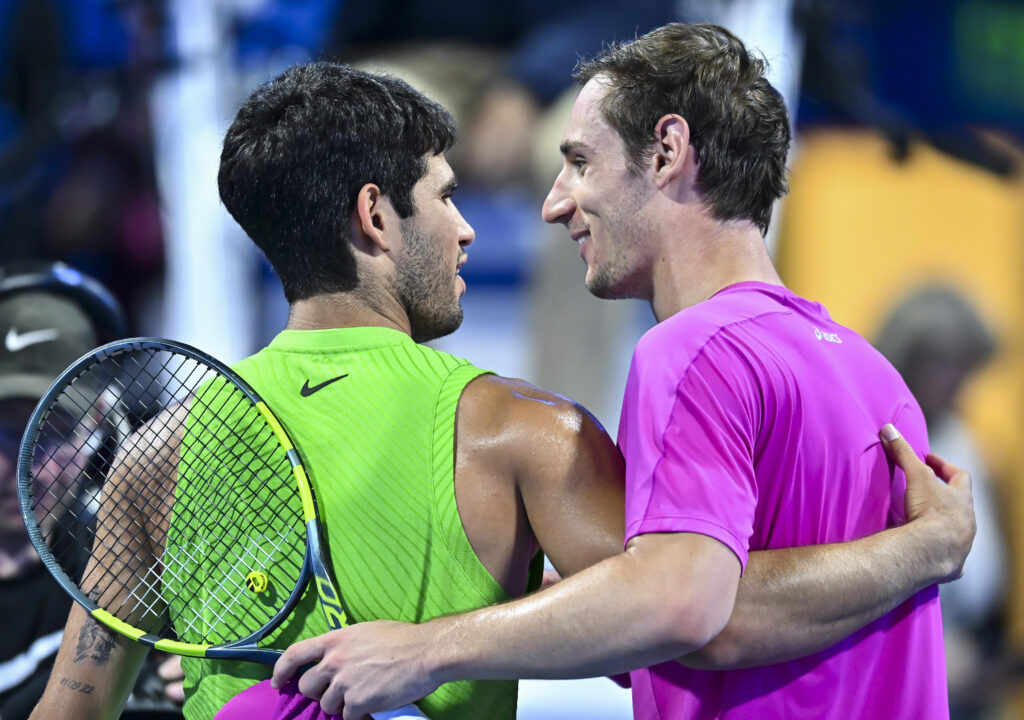 Carlos Alcaraz of Spain shakes hands with Valentin Royer of France after winning the Round of 16 at the ATP men's Qatar ExxonMobil Open 2026 tennis tournament at the Khalifa International Tennis Complex.