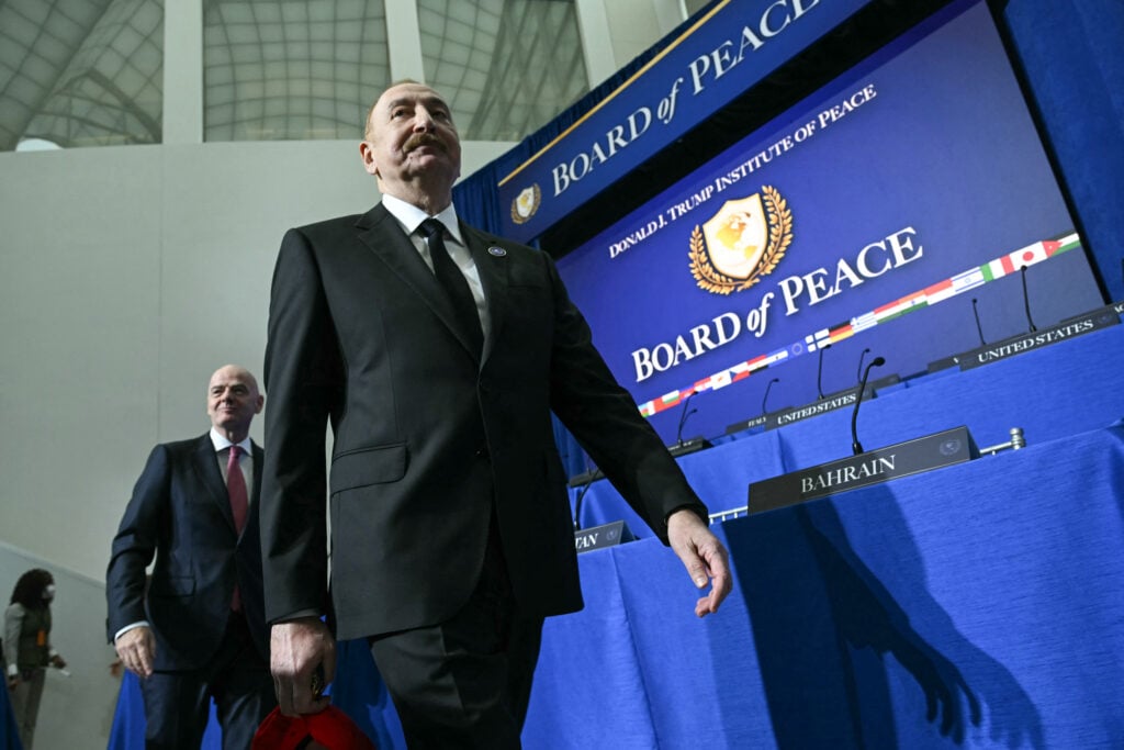 FIFA President Gianni Infantino and Azerbaijan's President Ilham Aliyev arrive to attend the inaugural meeting of the "Board of Peace" hosted by US President Donald Trump at the US Institute of Peace in Washington, DC, on February 19, 2026.