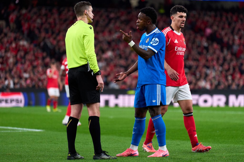 Vinicius Junior of Real Madrid speaks to Referee François Letexier during the UEFA Champions League 2025/26 League Knockout Play-off First Leg match between SL Benfica and Real Madrid C.F. at Estadio do SL Benfica.