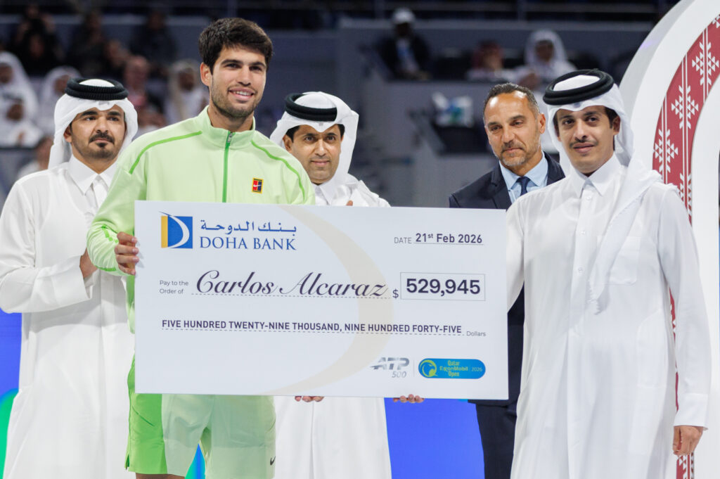 Carlos Alcaraz holds the cheque after winning the 2026 Qatar Open.