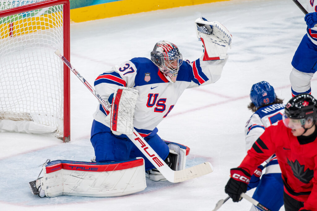 Goalie Connor Hellebuyck #37 of United States makes a glove save during the Men's Gold Medal match between Canada and United States on day sixteen of the Milano Cortina 2026 Winter Olympic games at Milano Santagiulia Ice Hockey Arena on February 22, 2026 in Milan, Italy.