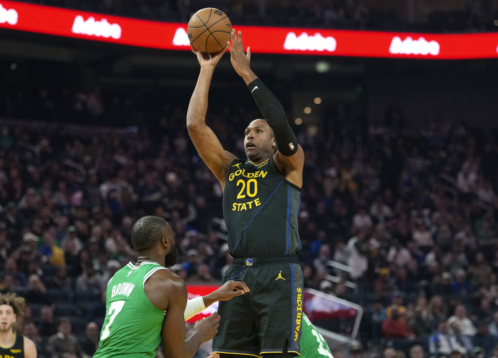 Al Horford #20 of the Golden State Warriors shoots over Jaylen Brown #7 of the Boston Celtics in the first half at Chase Center.