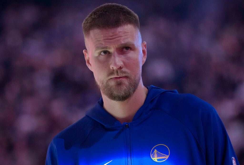 Kristaps Porzingis #7 of the Golden State Warriors looks on while standing for the national anthem prior to the start of the game against the Boston Celtics at Chase Center on February 19, 2026.