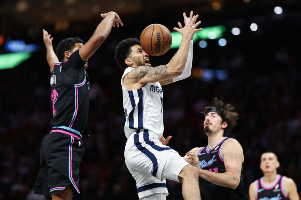 Dru Smith #12 of the Miami Heat blocks the ball against Scotty Pippen Jr. #1 of the Memphis Grizzlies during the first quarter of the game at Kaseya Center on February 21, 2026 in Miami, Florida.
