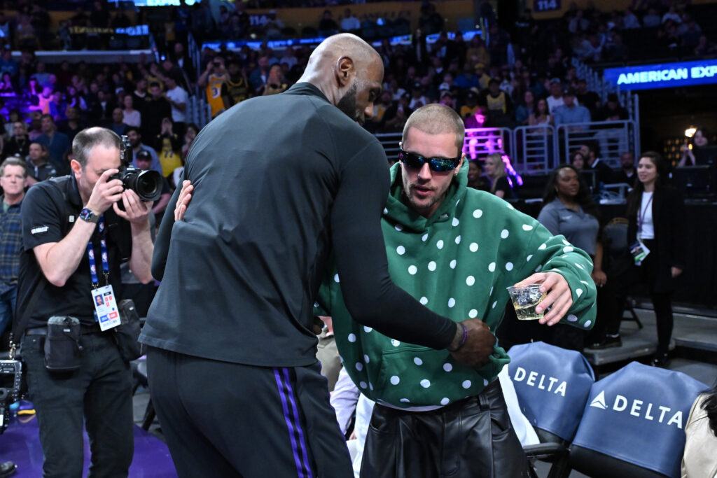 Justin Bieber (R) embraces LeBron James prior to a basketball game between the Los Angeles Lakers and the Orlando Magic at Crypto.com Arena.
