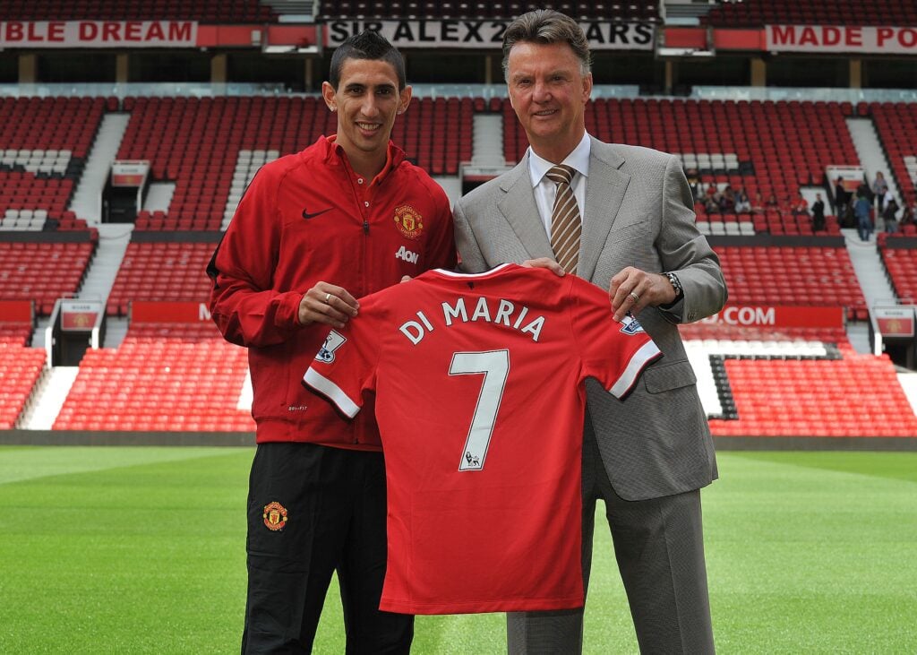 Manchester United's Dutch manager Louis van Gaal (R) poses with Manchester United's newly-signed Argentinian midfielder Angel di Maria (L) during an official presentation on the pitch at Old Trafford.