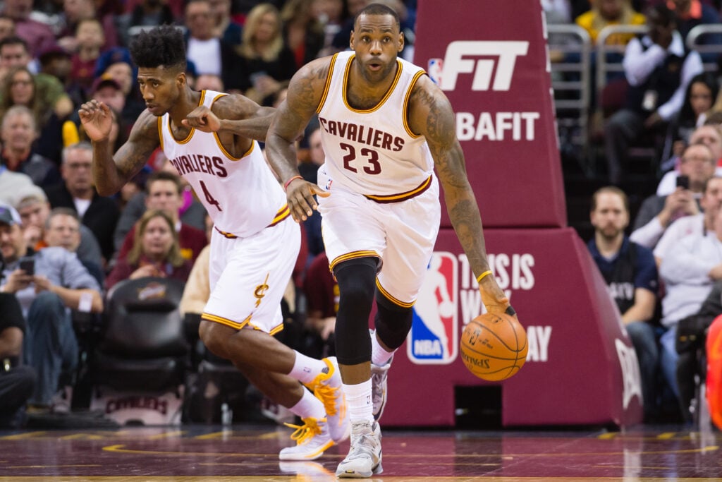 LeBron James #23 takes the ball down court followed by Iman Shumpert #4 of the Cleveland Cavaliers during the first half against the Chicago Bulls at Quicken Loans Arena.