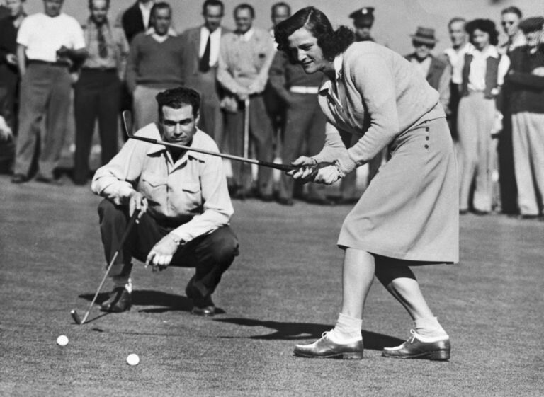 Babe Didrikson Zaharias drops a putt for a par four to halve first hole with Howard Teeter in their golf match at Brookside Park in the Pasadena Ci...