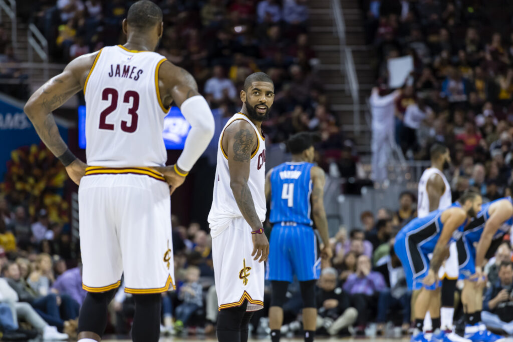 LeBron James #23 of the Cleveland Cavaliers talks to Kyrie Irving #2 on the court during the first half against the Orlando Magic at Quicken Loans Arena on April 4, 2017 in Cleveland, Ohio.