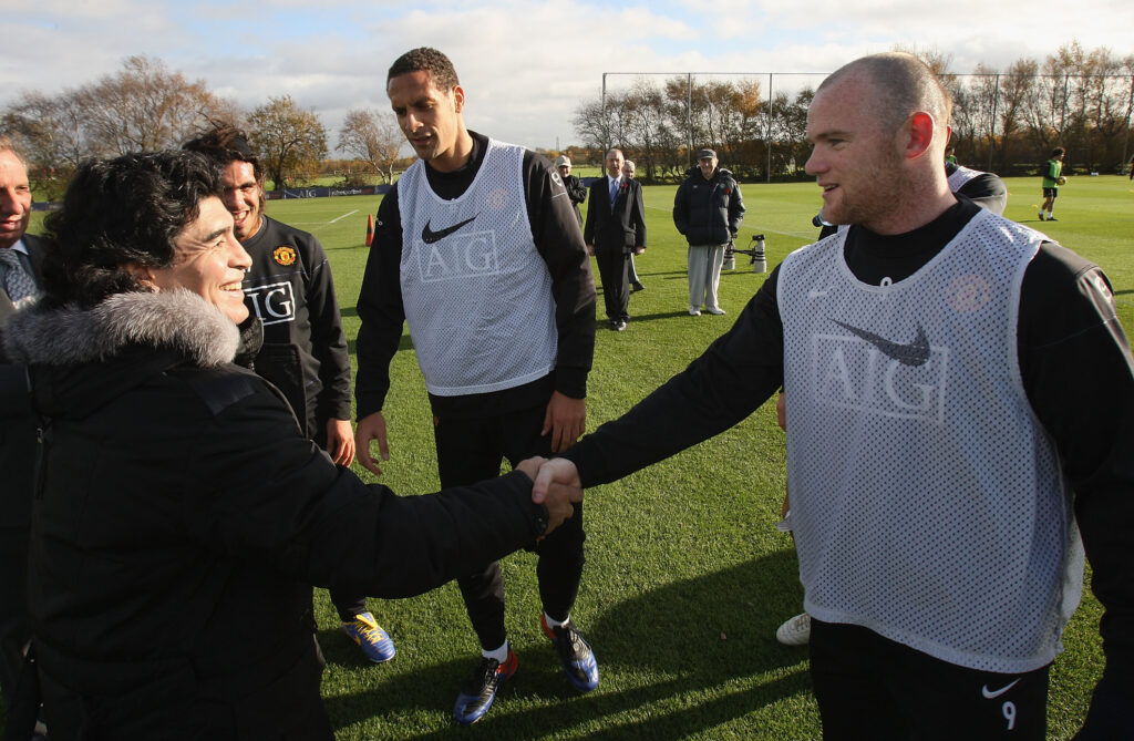 Wayne Rooney (R) of Manchester United greets Argentine national manager Diego Maradona during a First Team Training Session at Carrington Training Ground.