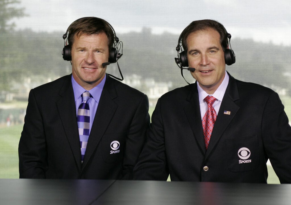 CBS announcers Nick Faldo (L) and Jim Nantz in the broadcast booth at the 18th green during the third round of the AT&T Pebble Beach National Pro-Am