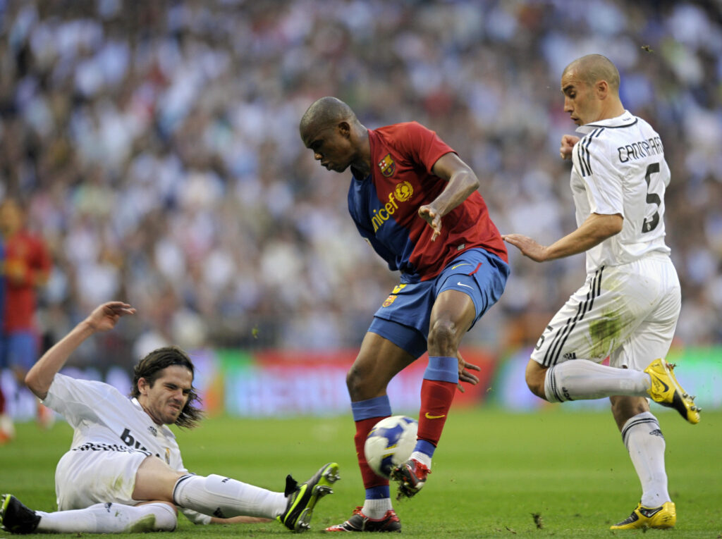 Barcelona's Cameroonian forward Samuel Eto´o (C) fights for the ball with Real Madrid's Argentinian midfielder Fernando Gago (L) and Italian defender Fabio Cannavaro (R) during their Spanish League football match at the Santiago Bernabeu stadium in Madrid.