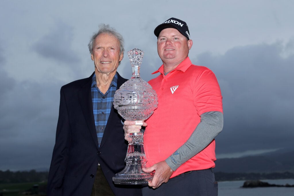Clint Eastwood and Ted Potter Jr. pose with the trophy after Potter won the AT&T Pebble Beach Pro-Am