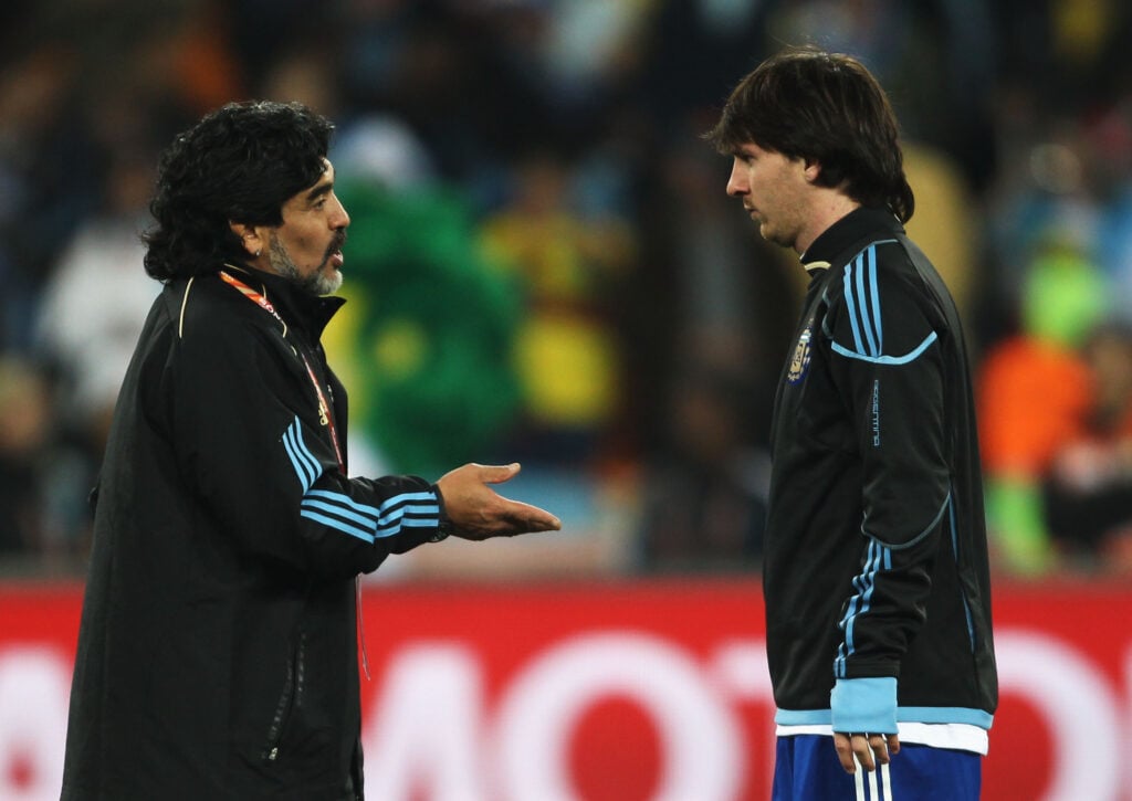 Diego Maradona head coach of Argentina talks to Lionel Messi during the warm up before the 2010 FIFA World Cup South Africa Round of Sixteen match between Argentina and Mexico at Soccer City Stadium.