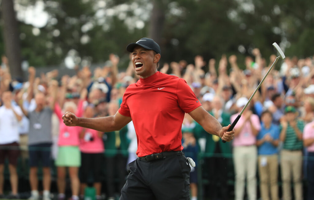 Tiger Woods (L) of the United States celebrates on the 18th green after winning the Masters at Augusta National Golf Club