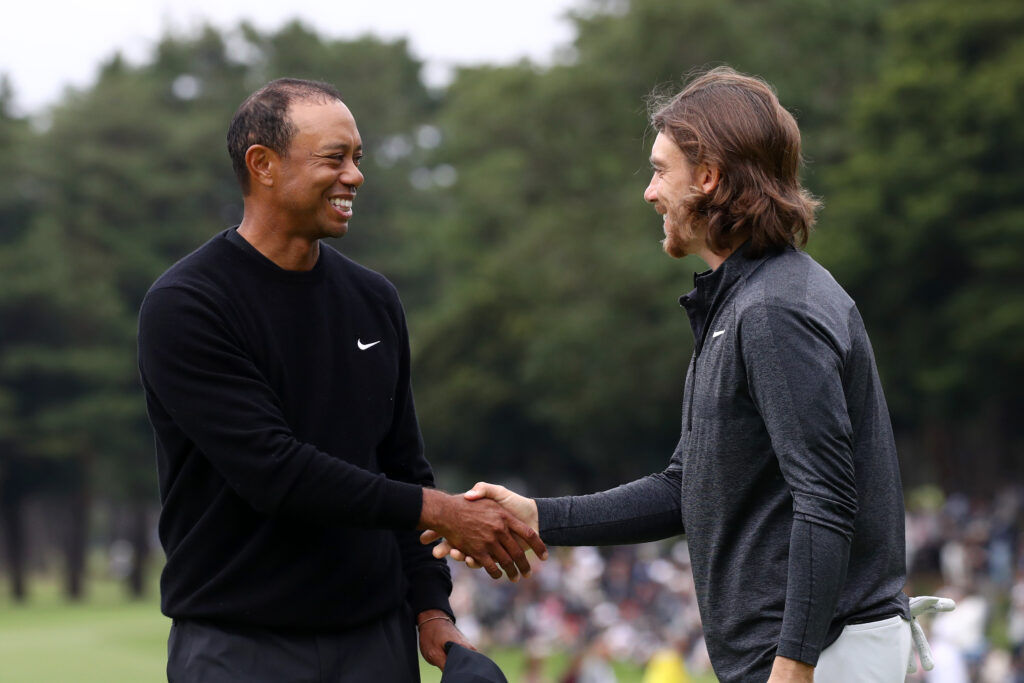 Tiger Woods and Tommy Fleetwood shake hands on the 9th green during the first round of the ZOZO Championship