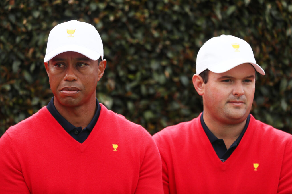 Playing Captain Tiger Woods of the United States team and Patrick Reed of the United States team look on during their team photo ahead of the 2019 Presidents Cup at Royal Melbourne Golf Course