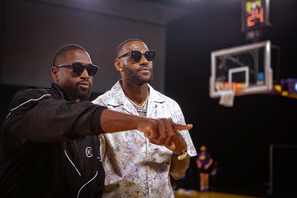 Lebron James and Dwyane Wade attend a Los Angeles Sparks WNBA game.
