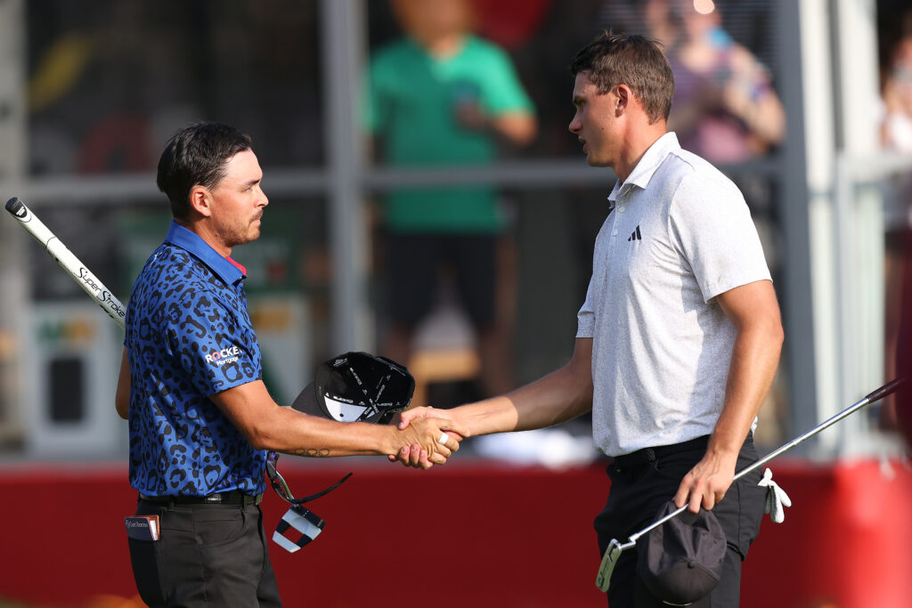 Rickie Fowler (left) and Ludvig Aberg of Sweden shake hands after finishing the 18th hole during the third round of the Rocket Mortgage Classic