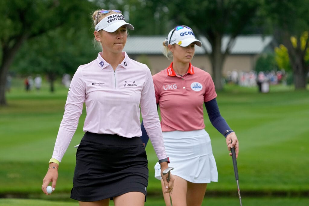 Jessica Korda of the United States (L) and Nelly Korda of the United States walk across the fifth green during the final round of the Dow Great Lakes Bay Invitational