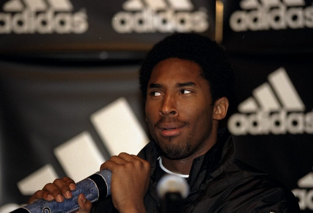 Kobe Bryant with a Didgeridoo at a press conference during an Adidas promotional tour.
