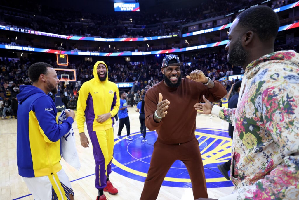 Draymond Green #23 and Stephen Curry #30 of the Golden State Warriors jokes with Anthony Davis #3 and LeBron James #23 of the Los Angeles Lakers after their game at Chase Center on October 07, 2023 in San Francisco, California.