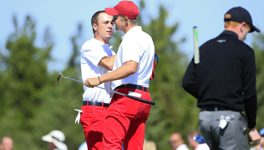 Patrick Rodgers (R) and Justin Thomas of the United States celebrate winning their match on the 17th green during the Day One morning foursome matches of the 2013 Walker Cup