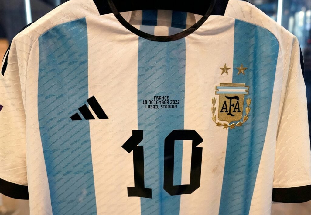 The shirt worn in the 2022 World Cup final match between Argentina and France on December 18, 2022, is displayed during a Sotheby's auction media preview of six 2022 FIFA World Cup match-worn shirts belonging to Inter Miami's Argentine forward #10 Lionel Messi, in New York City.
