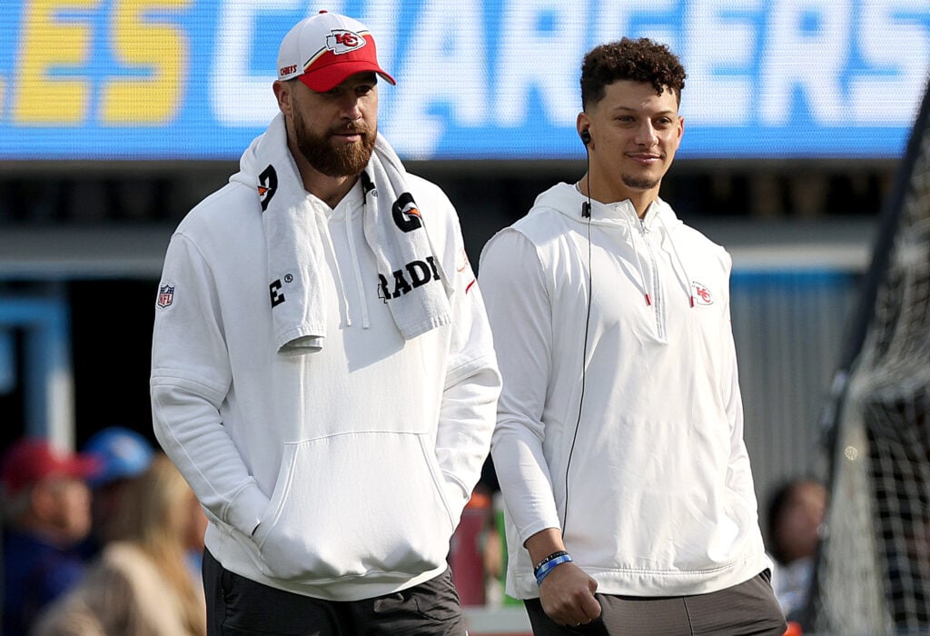 Travis Kelce #87 of the Kansas City Chiefs and Patrick Mahomes #15 of the Kansas City Chiefs look on from the sidelines during a game against the Los Angeles Chargers at SoFi Stadium.