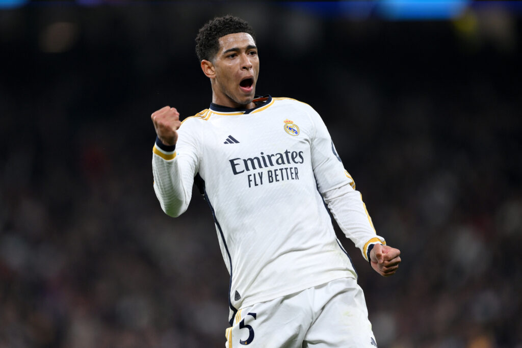 Jude Bellingham of Real Madrid celebrates after Vinicius Junior of Real Madrid scores his team's first goal during the UEFA Champions League 2023/24 round of 16 second leg match between Real Madrid CF and RB Leipzig