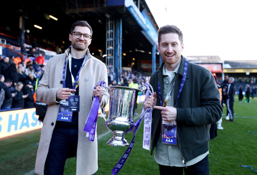 Spencer Owen, Founder and Chairman of Hashtag United, and Seb Carmichael-Brown, Founder and Commercial Director of Hashtag United, pose for a photo with the FA Women's National League Cup trophy after their team's victory the FA Women's National League Cup Final between Newcastle United and Hashtag United.