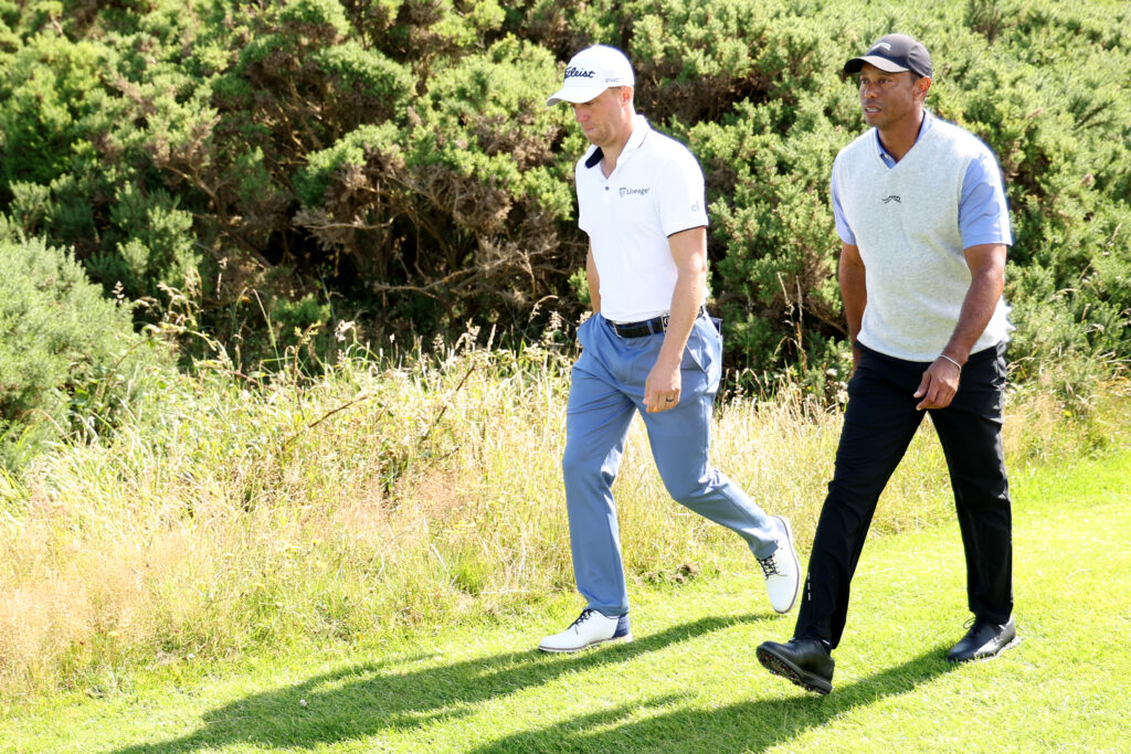 Tiger Woods and Justin Thomas walk down the fairway prior to The 152nd Open championship at Royal Troon