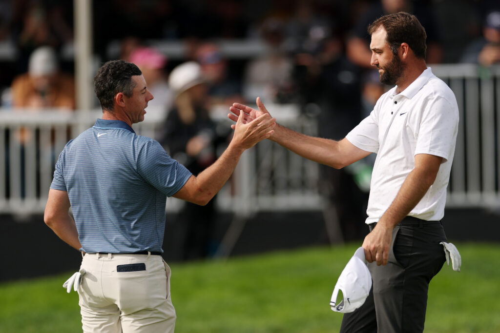 Rory McIlroy of Northern Ireland (L) and Scottie Scheffler of the United States shake hands on the 18th green after their round during the final round of The Genesis Invitational 2025