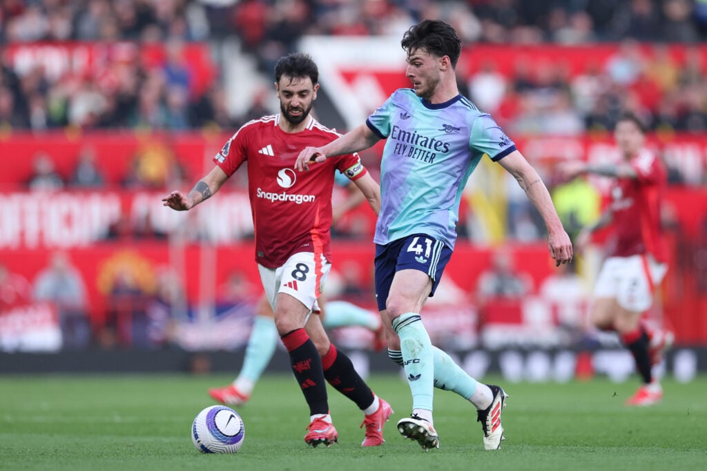 Declan Rice of Arsenal battles for possession with Bruno Fernandes of Manchester United during the Premier League match between Manchester United FC and Arsenal FC at Old Trafford.