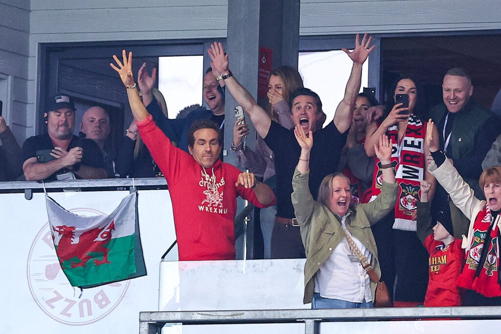 Rob McElhenney and Ryan Reynolds co-owners of Wrexham react at full time as they secure promotion to the Championship during the Sky Bet League One match between Wrexham AFC and Charlton Athletic FC at Racecourse Ground on April 26, 2025 in Wrexham, Wales.
