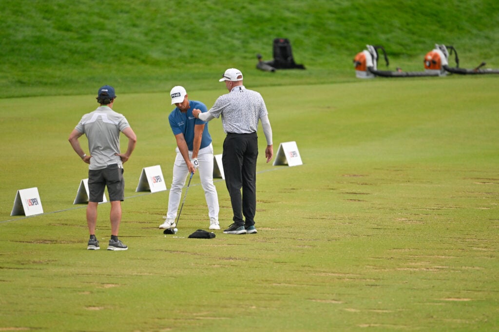 Viktor Hovland works alone on the range after the third round of the US Open at Oakmont