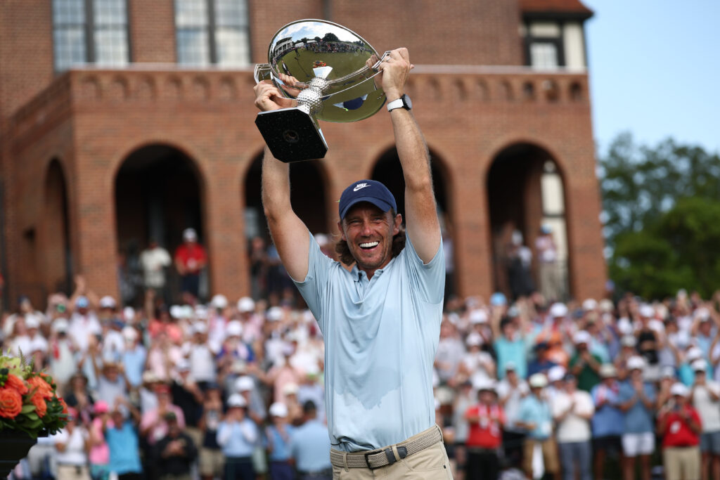 Tommy Fleetwood of England celebrates with the Fedex Cup trophy after winning the final round of the TOUR Championship 2025 at East Lake Golf Club