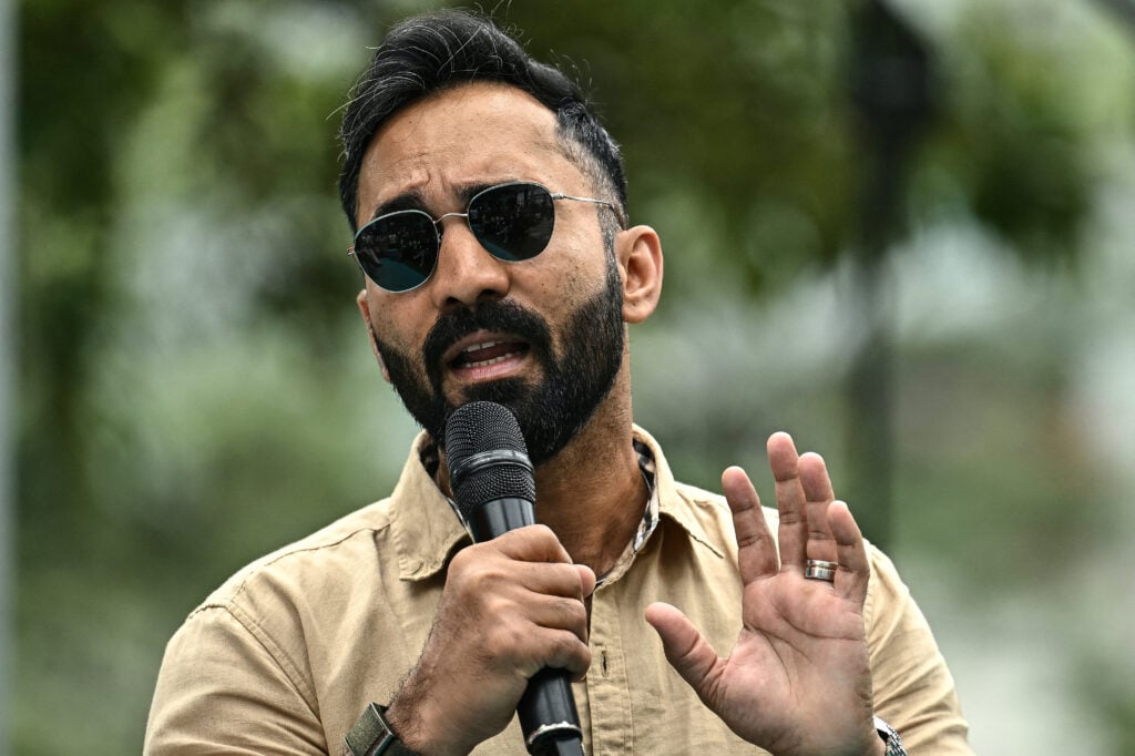 Former Indian cricketer Dinesh Karthik speaks during the unveiling of the ICC Women's Cricket World Cup Trophy.