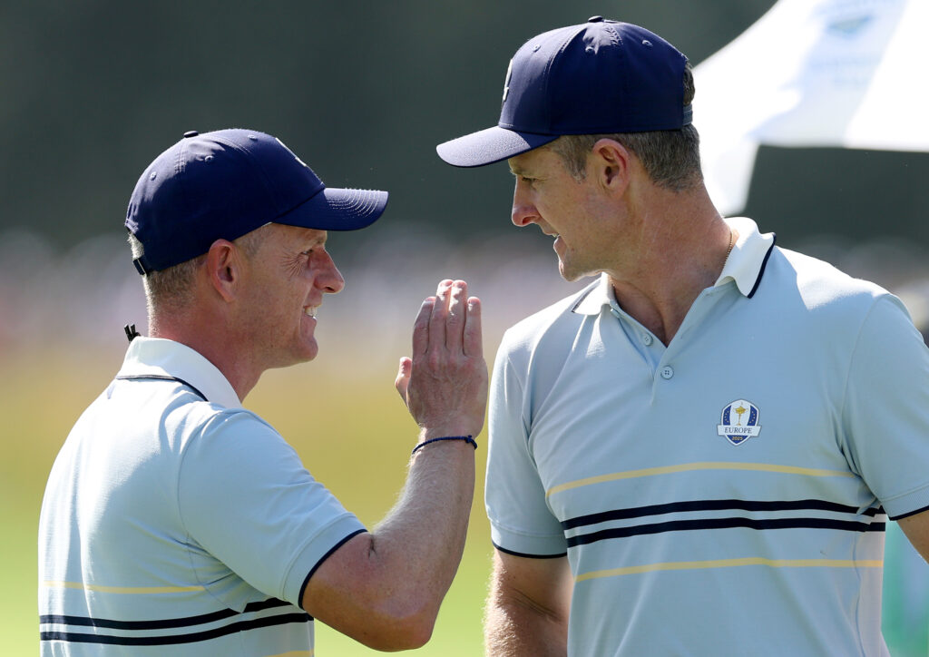 Captain Luke Donald of Team Europe congratulates Justin Rose of Team Europe