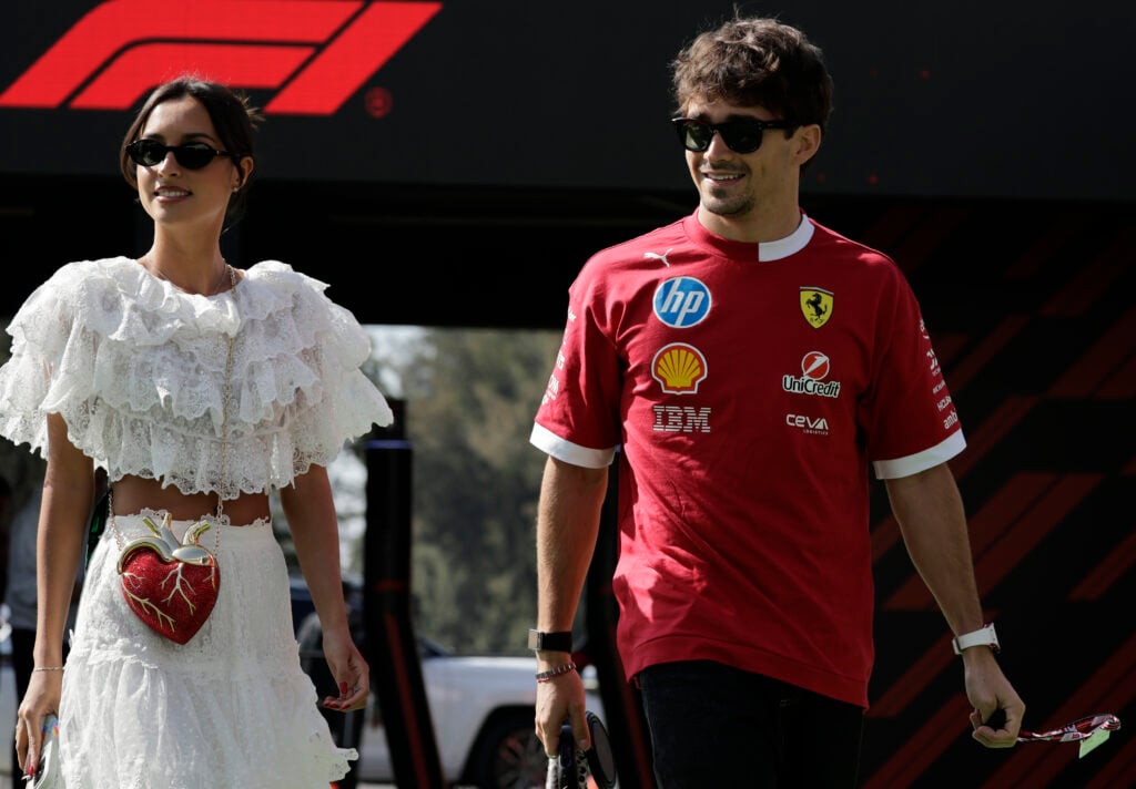 Ferrari driver Charles Leclerc, accompanied by his partner Alexandra Saint Mleux and their pet Leo, arrives at the Autodromo Hnos. Rodriguez in Mexico City, Mexico, on October 24, 2025, prior to practice for the F1 Grand Prix.